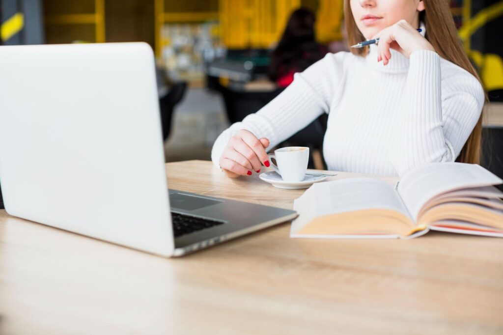 Woman working with laptop in cafe