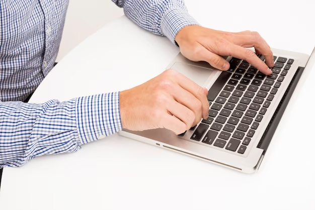 Male hands on laptop keyboard